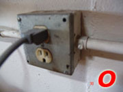 an electrical outlet with the letter o next to it