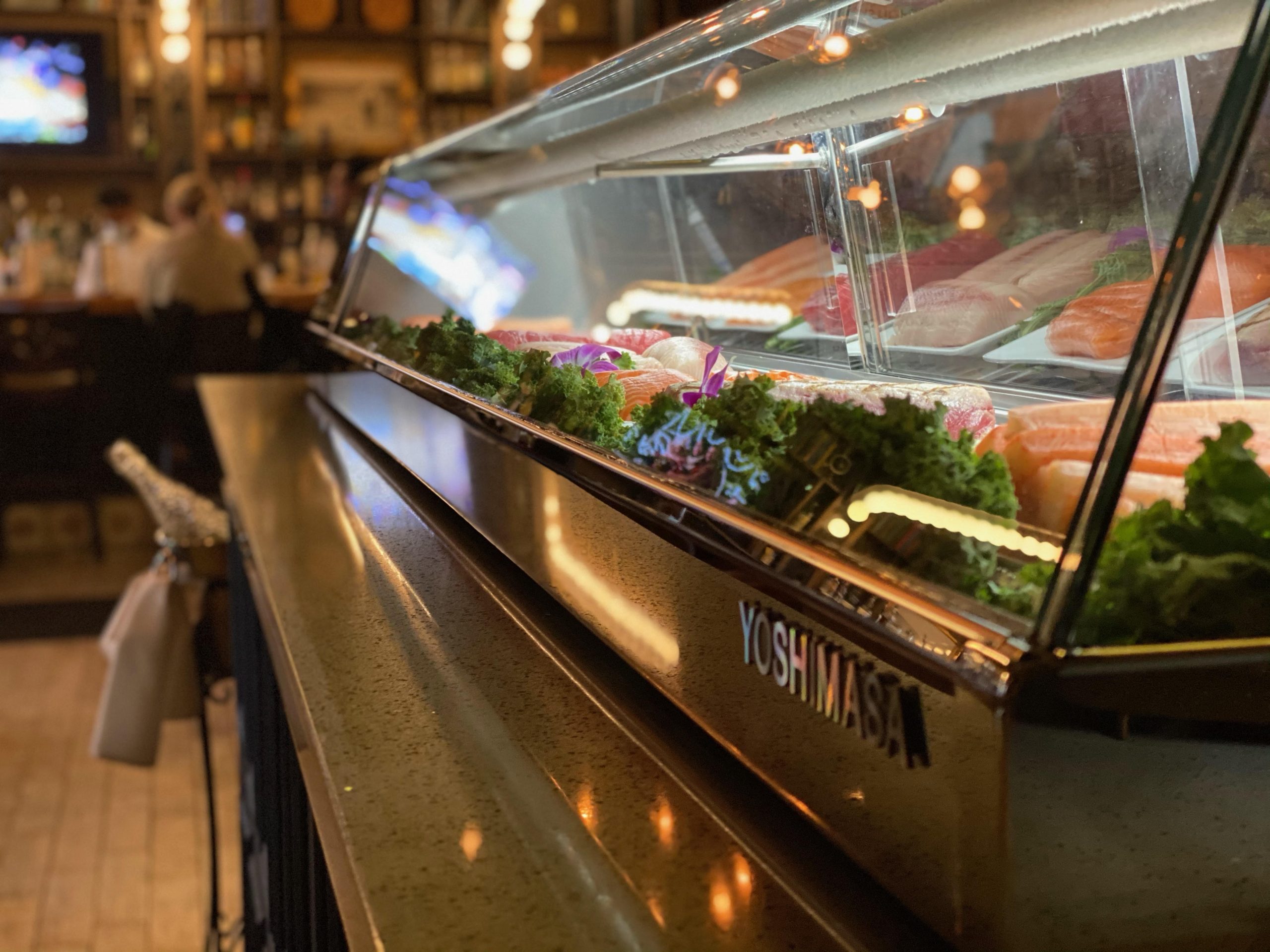 A glass display case at a restaurant called oyster society