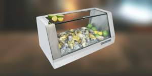 A glass display case filled with oysters and limes