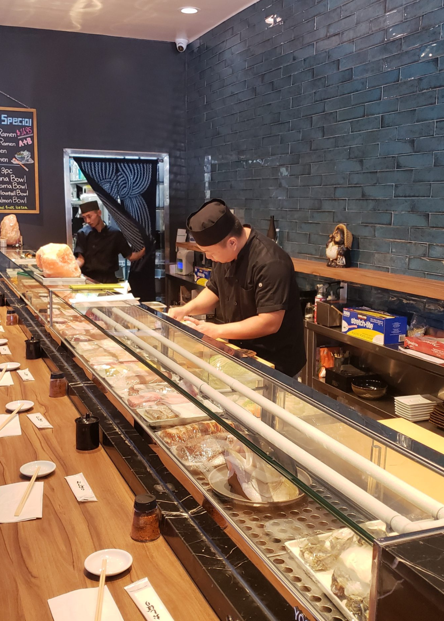 a chef prepares food in front of a sign that says special